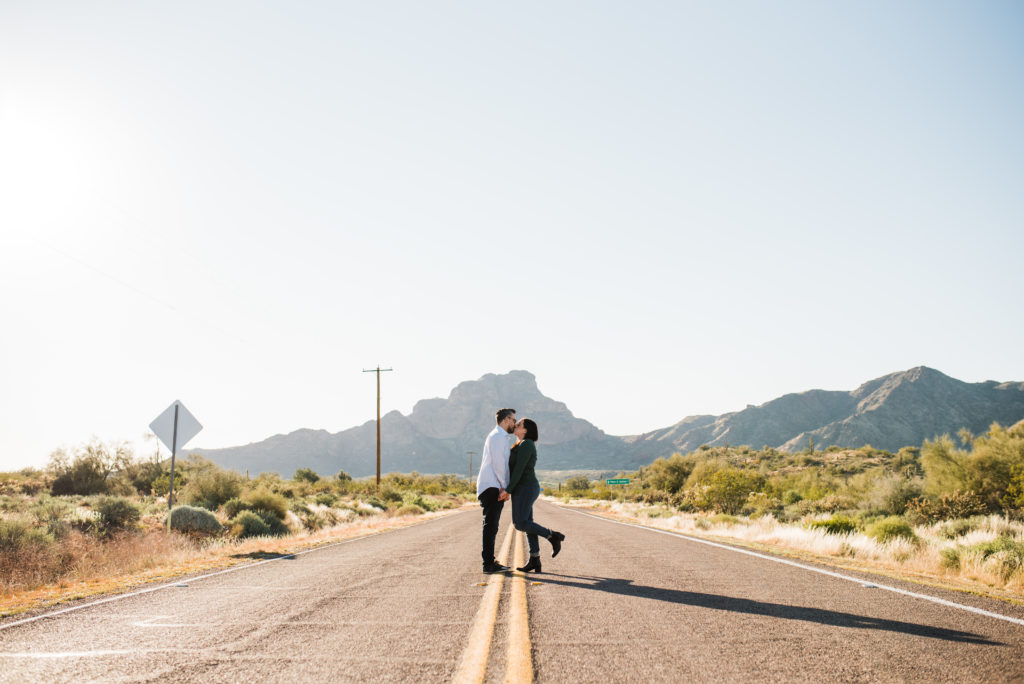 Engagement session kissing in middle of road 