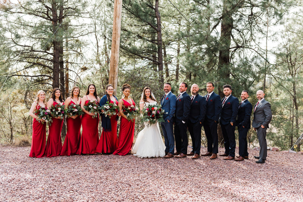 Bridal party photo in front of pine trees