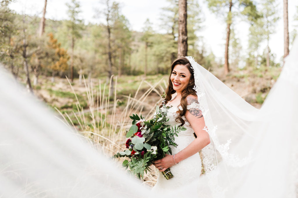 bridal portrait smiling with long veil at their Cabins on Strawberry Hill Wedding