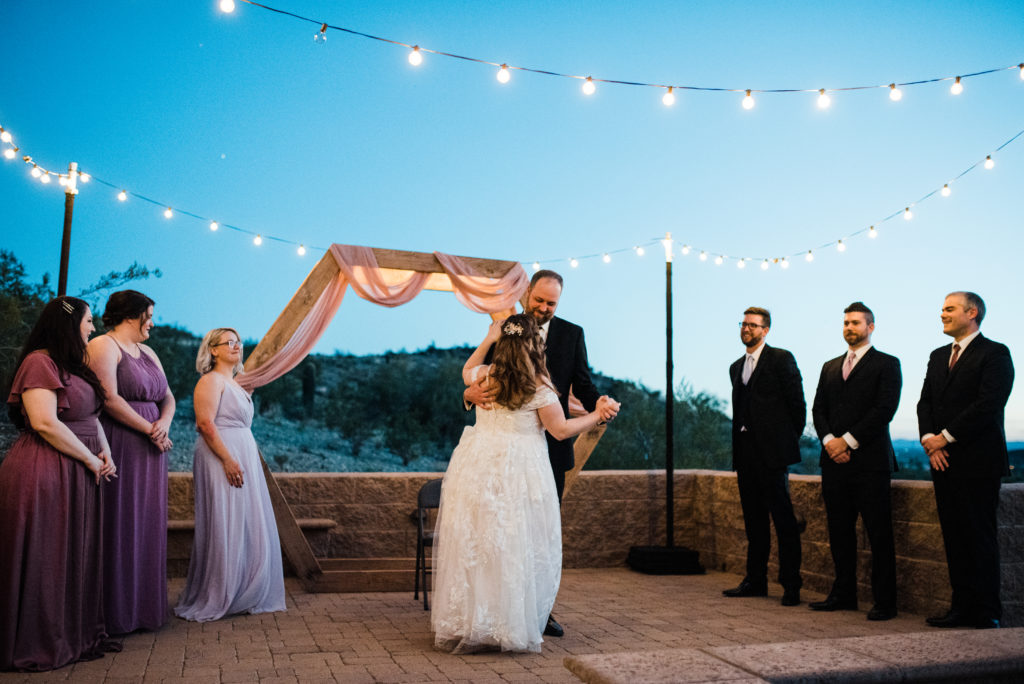 first dance in the desert with the sun setting behind 