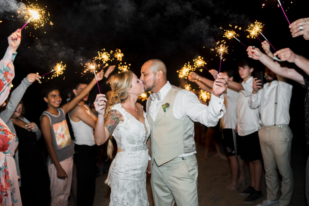 california dream beach wedding bride and groom portraits for sparkler exit night shot 