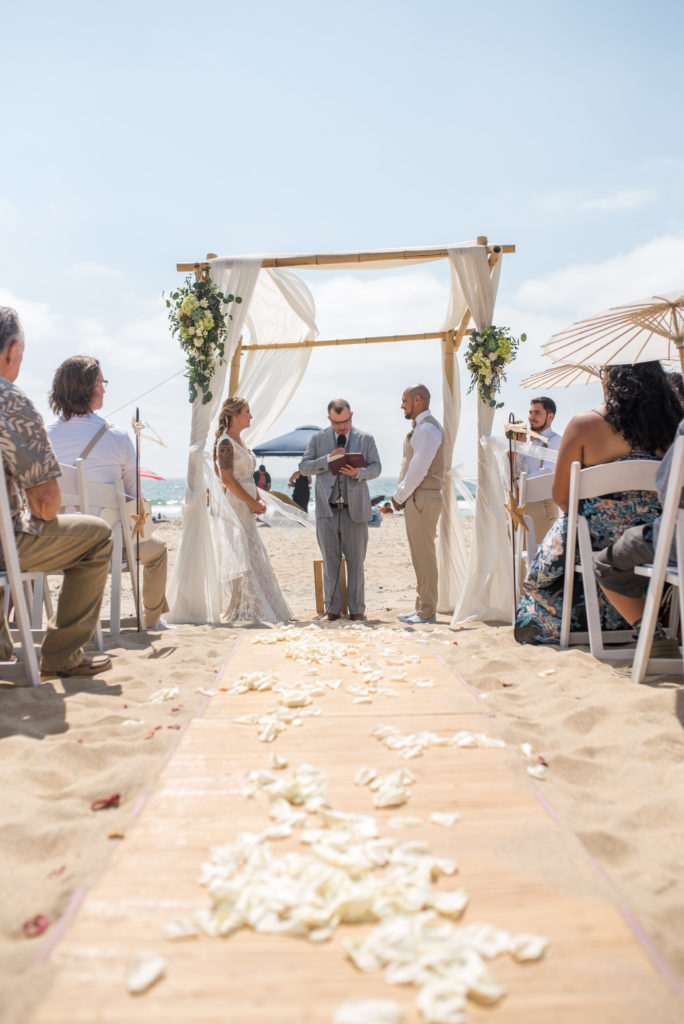 bride and groom at ceremony site on the beach 