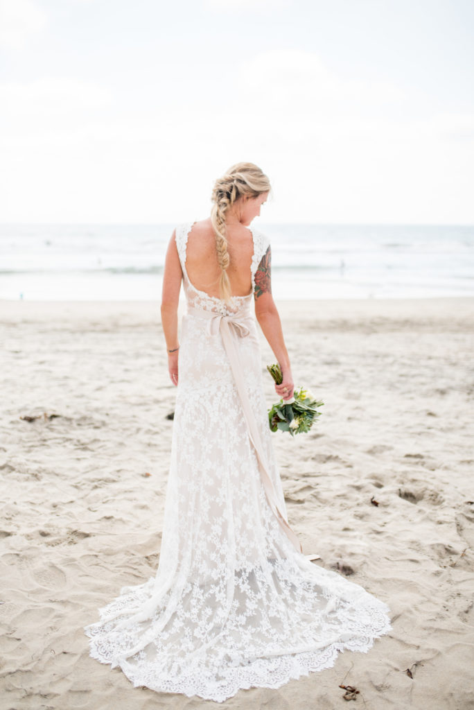 california dream beach wedding bride  back of dress with succulent bouquet 