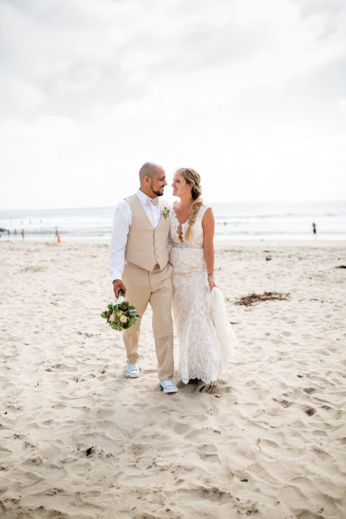 california dream beach wedding bride and groom portraits walking on the beach 