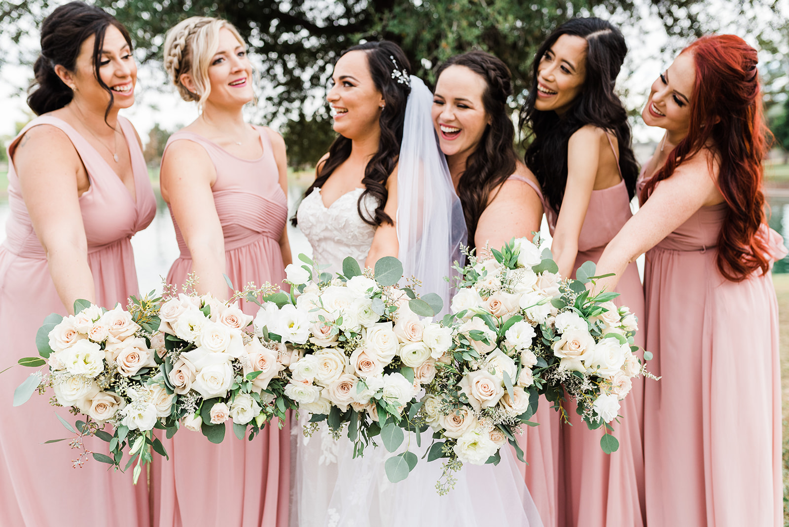 bride laughing with her bridesmaids wearing pink at her ADERO Scottsdale Wedding
