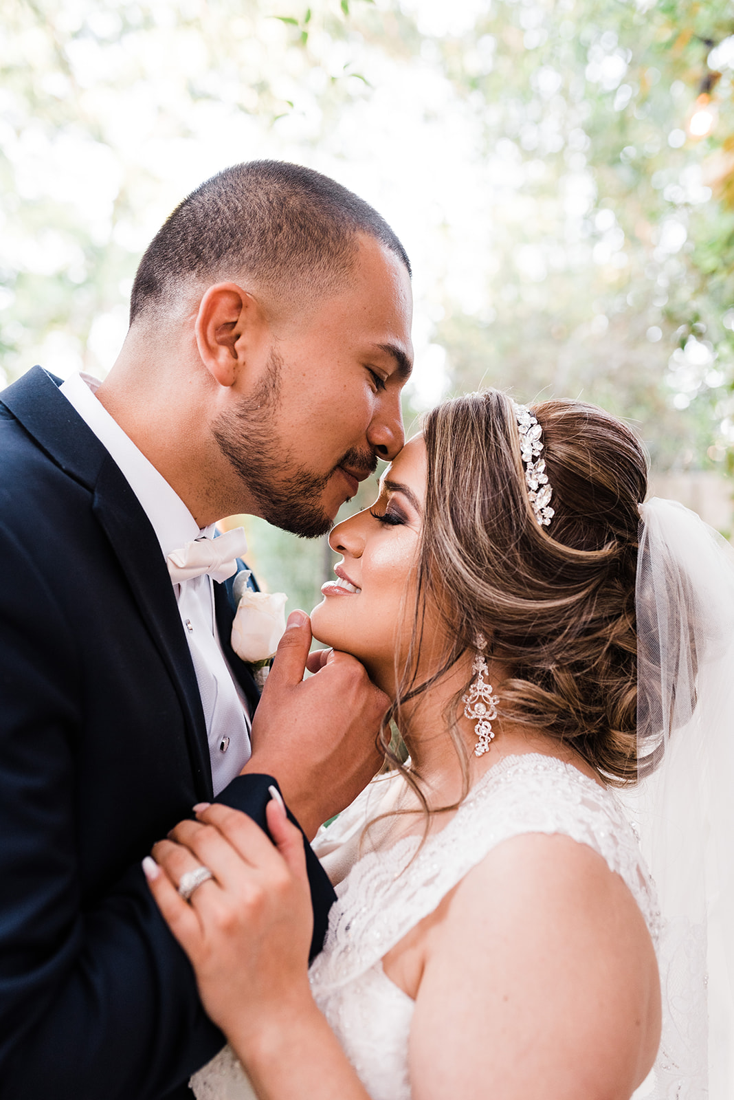groom kissing his bride on the forehead at the Secret Garden Phoenix wedding venue