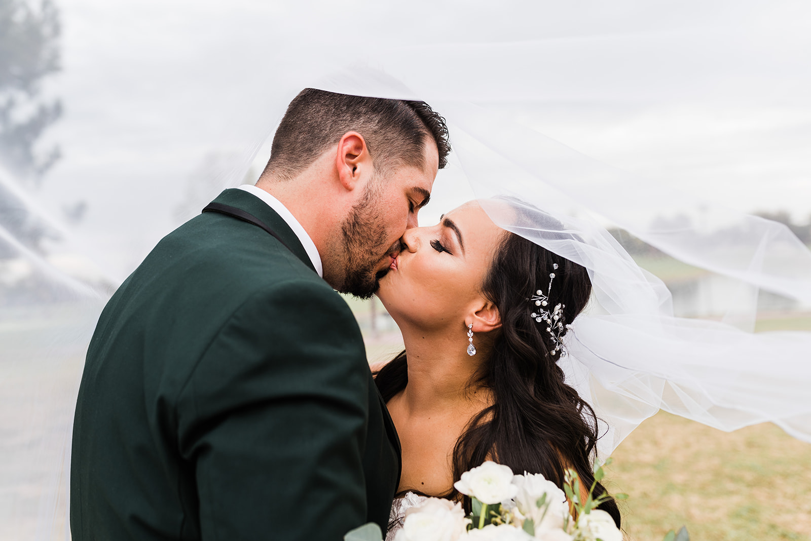 bride and groom kissing under a veil Clayton House Wedding