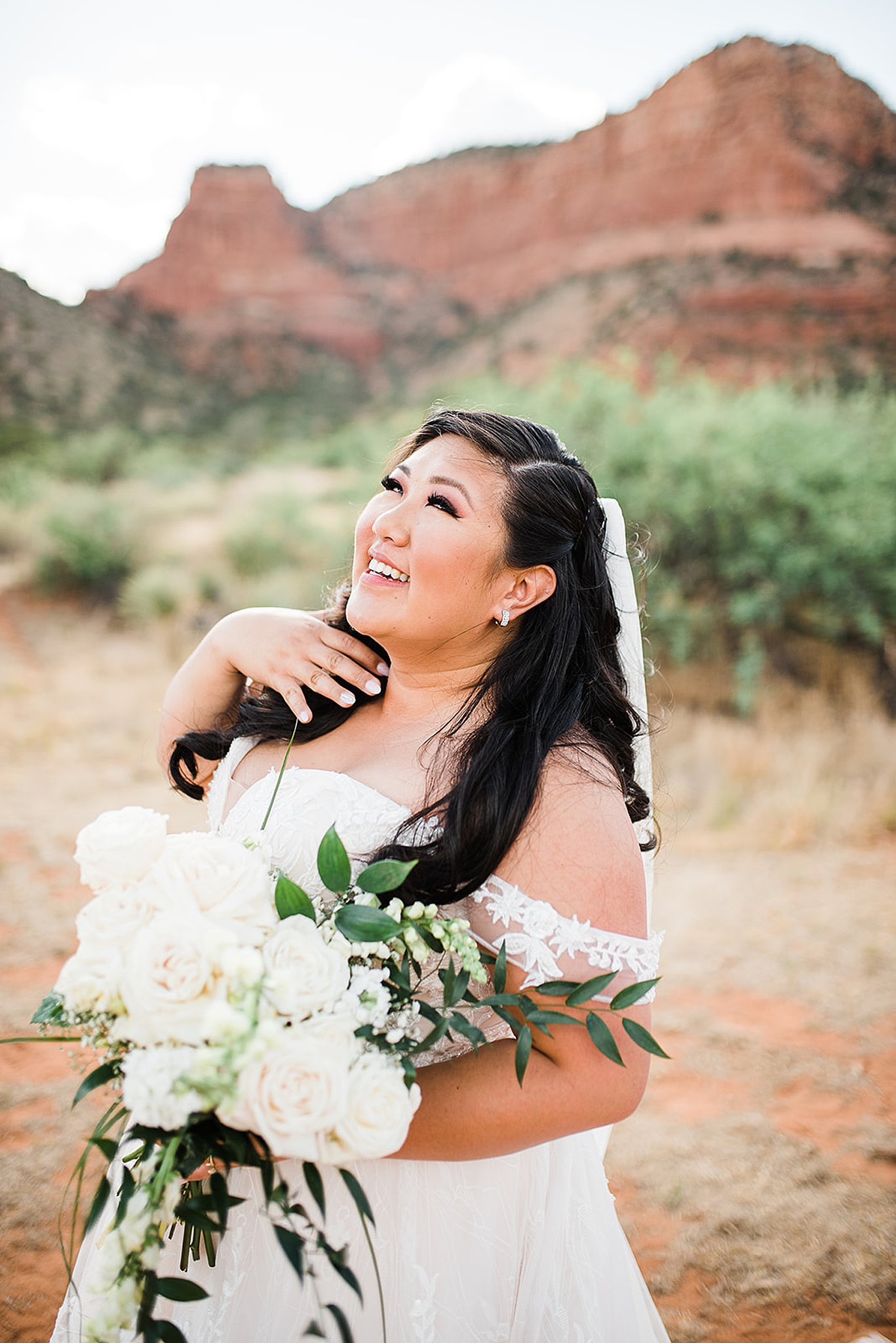 bride standing near the red rocks at her Enchantment Resort wedding