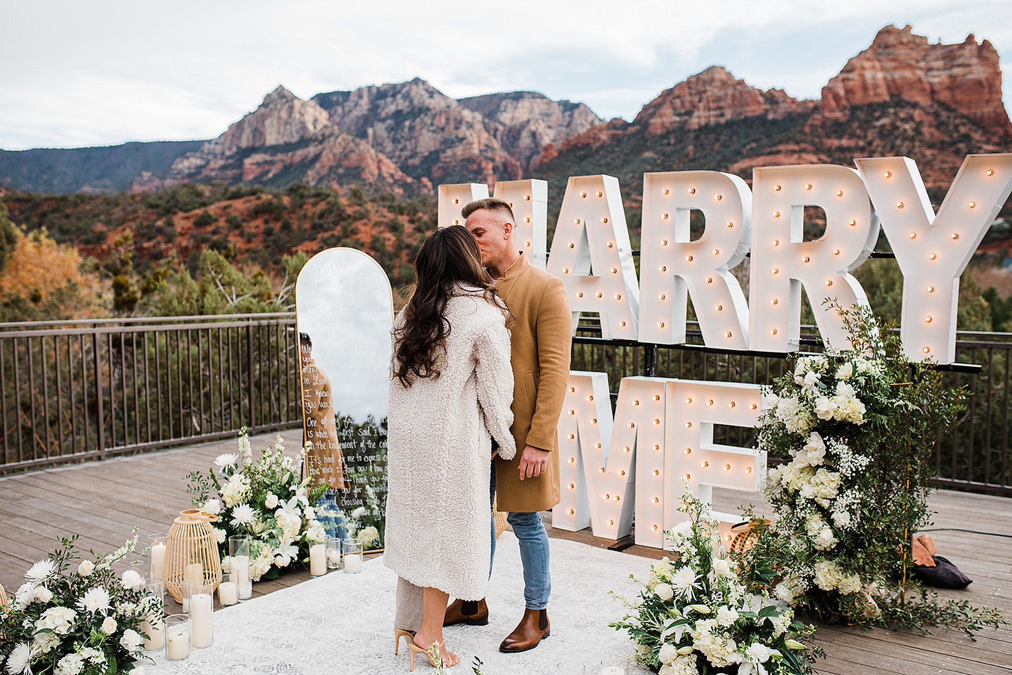 couple sharing a kiss at a L'Auberge De Sedona proposal after she said yes