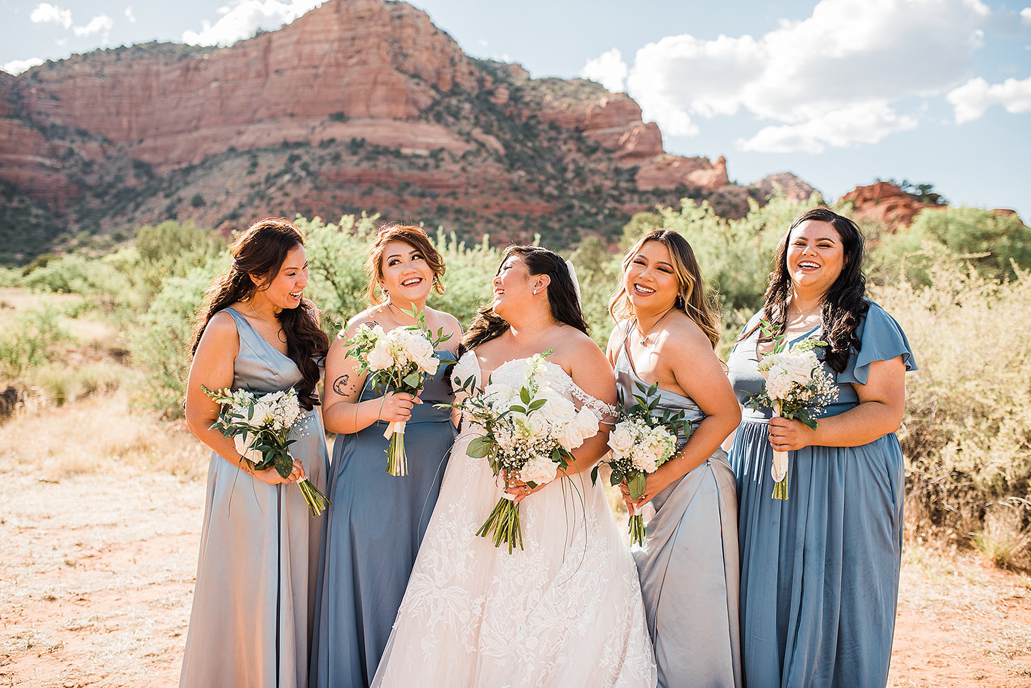 bride laughing with her bridesmaids