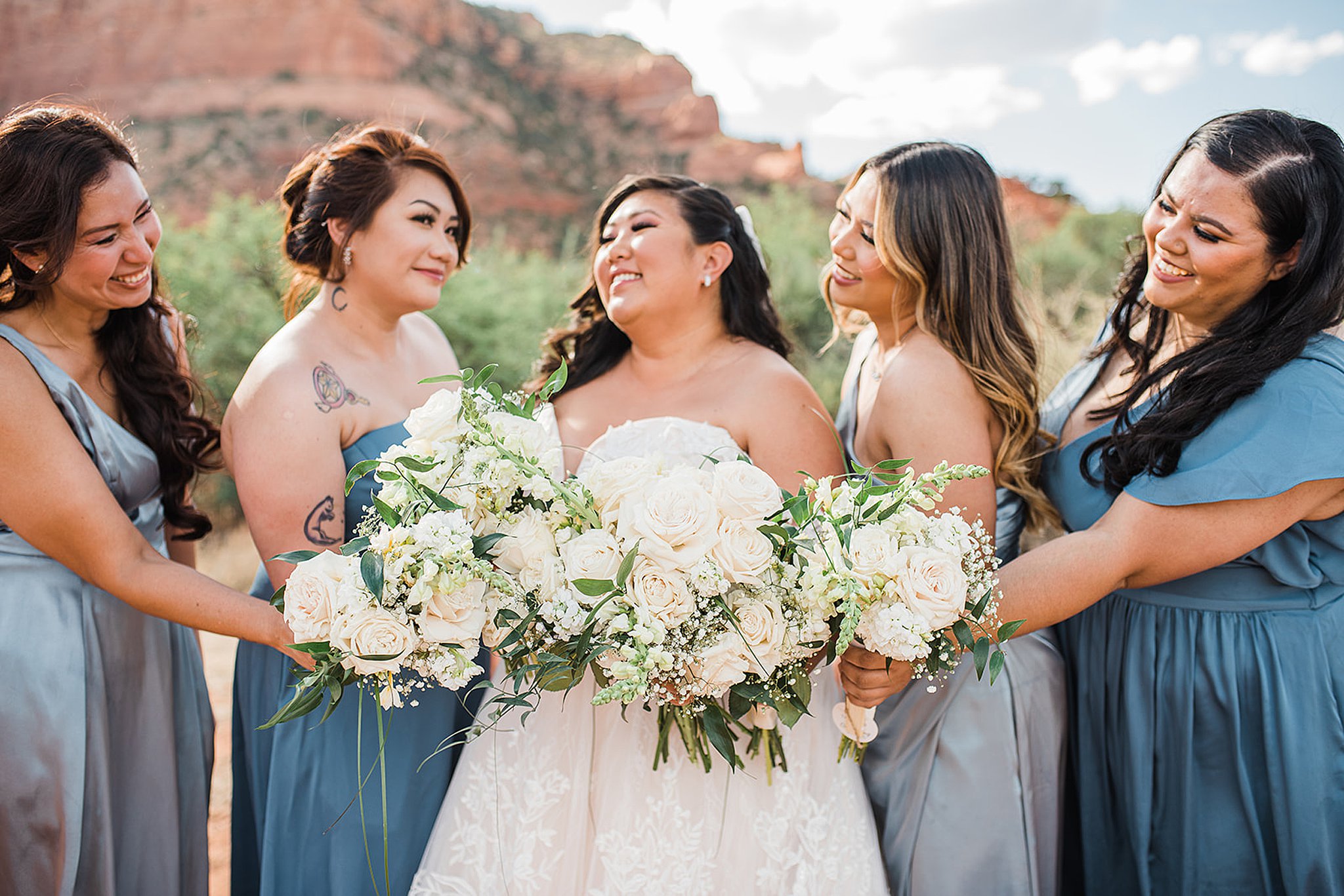 bride and her bridesmaids in blue and grey