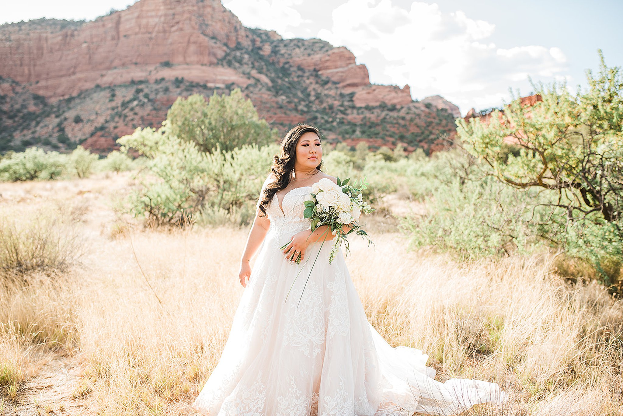 bride standing in front of the red rocks at the red agave resort