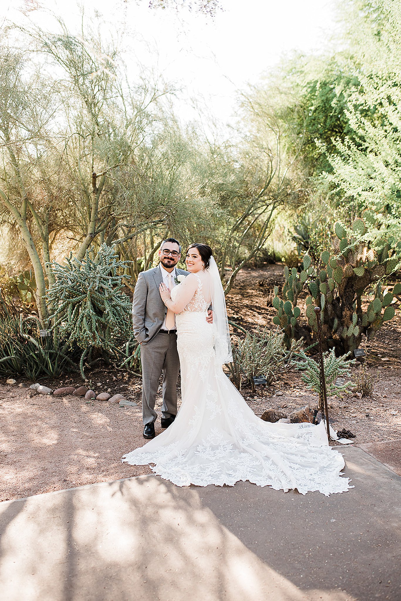 bride and groom embracing each other at their desert botanical gardens wedding