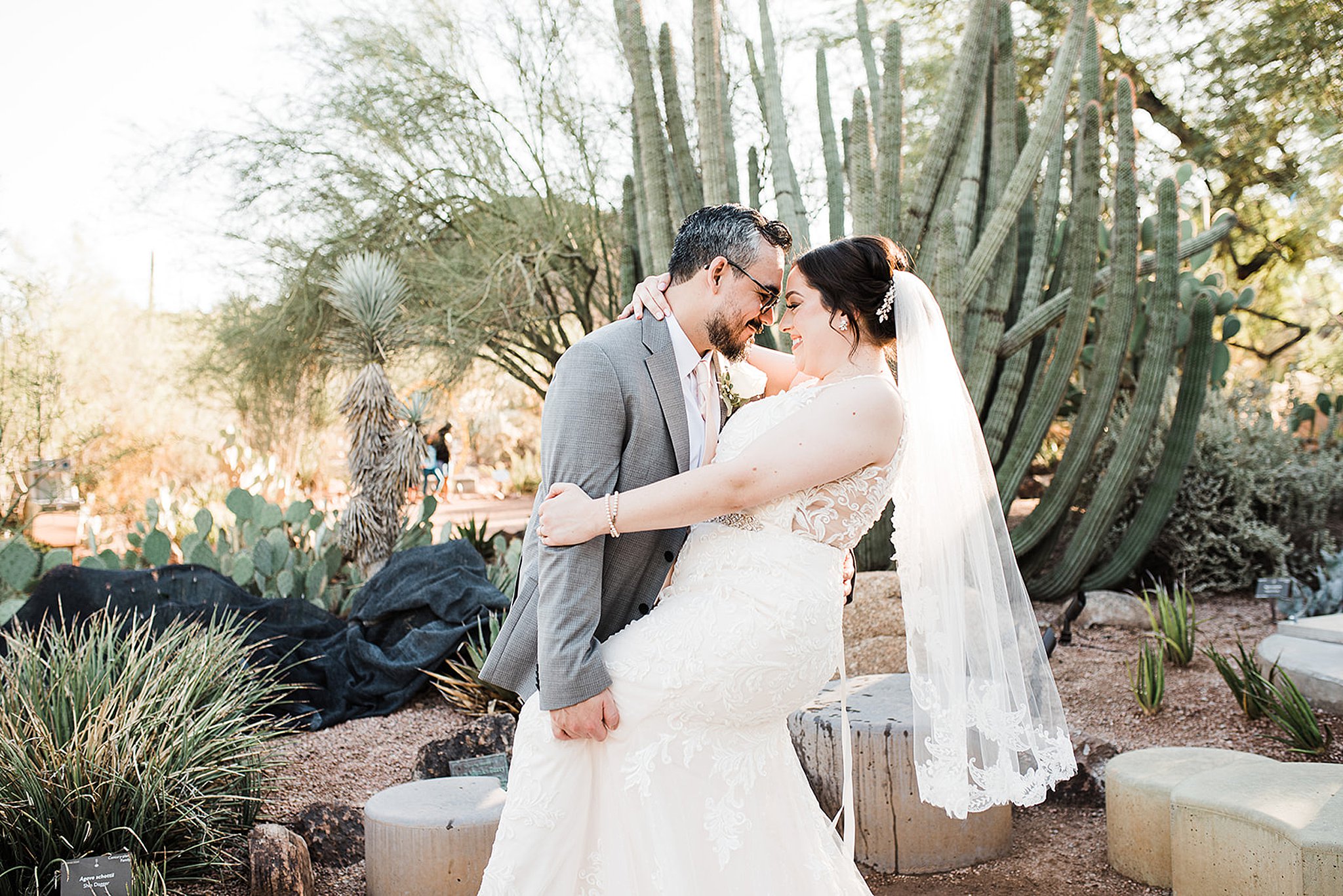 groom dipping his bride's back at their desert botanical gardens wedding