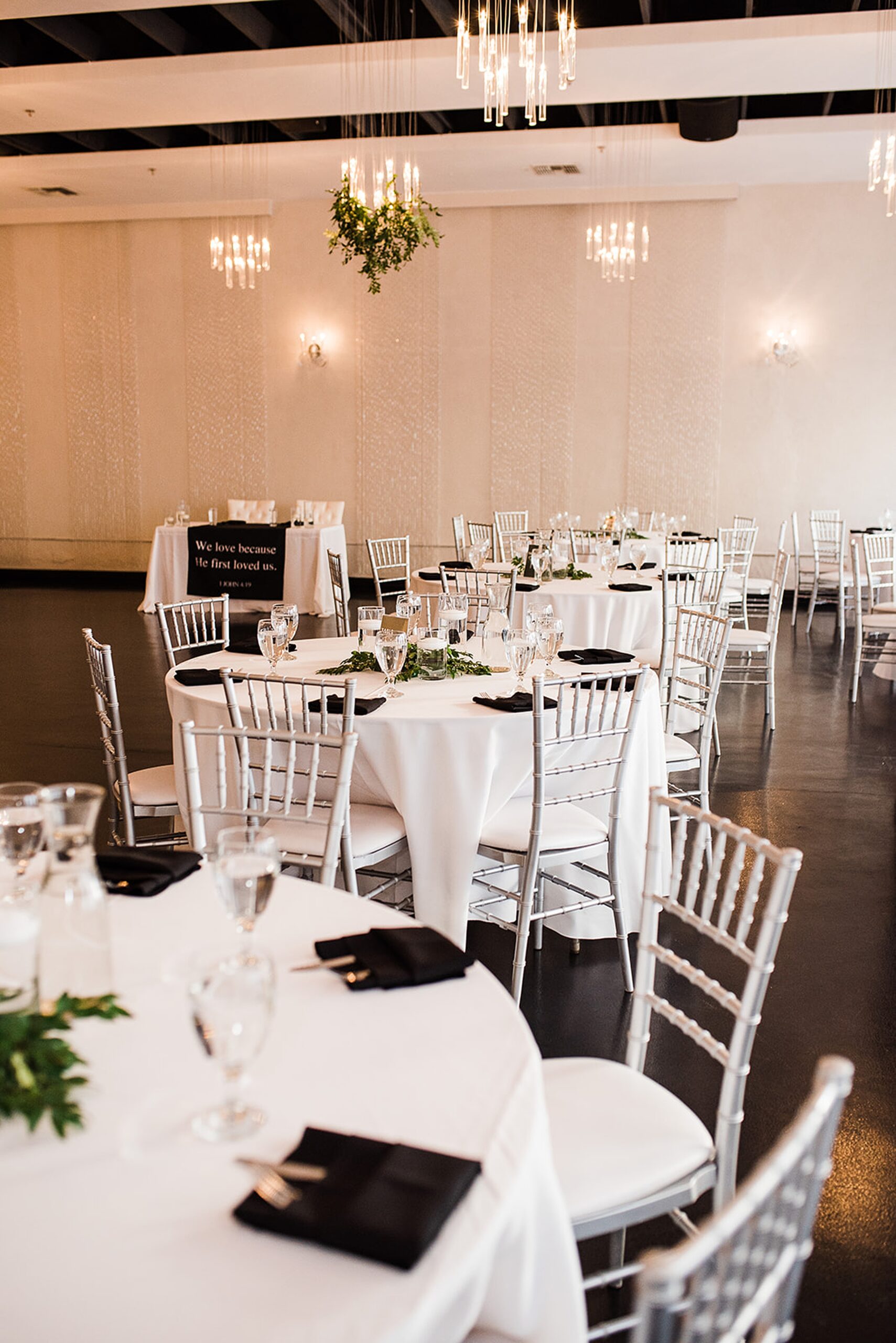 Details of a reception set up with white and black linens
